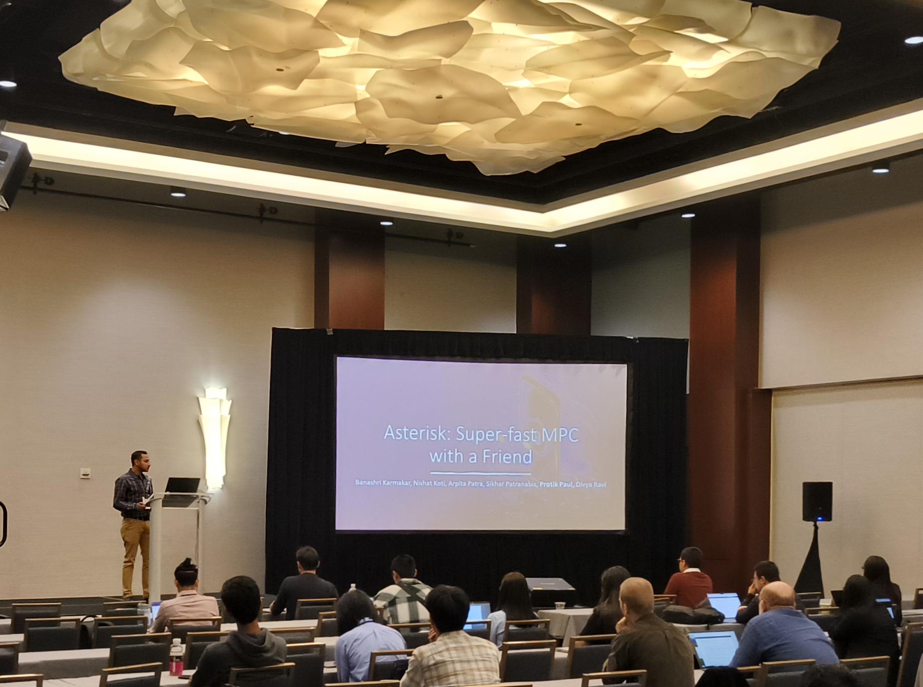 Protik presenting the Asterisk title slide to a conference audience